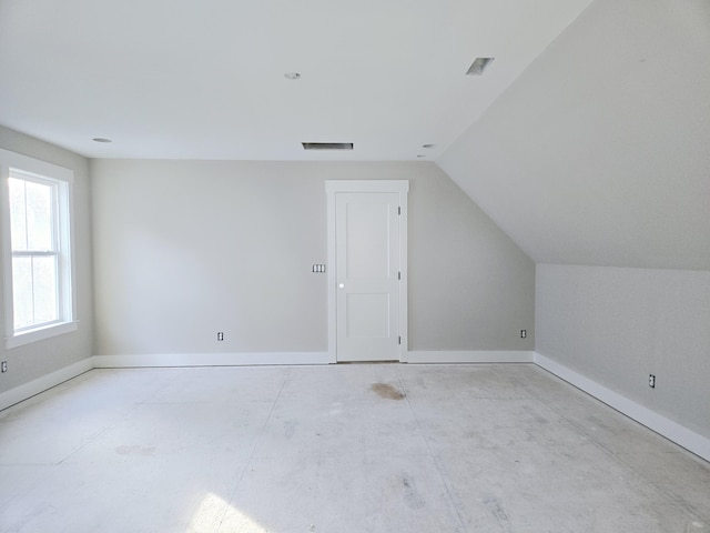 additional living space featuring vaulted ceiling