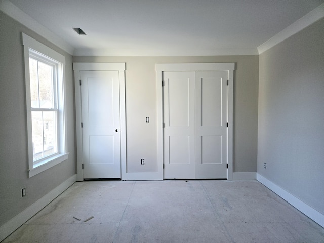 unfurnished bedroom featuring multiple windows