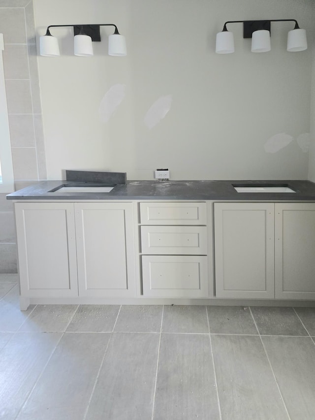 bathroom featuring tile patterned flooring and dual sinks