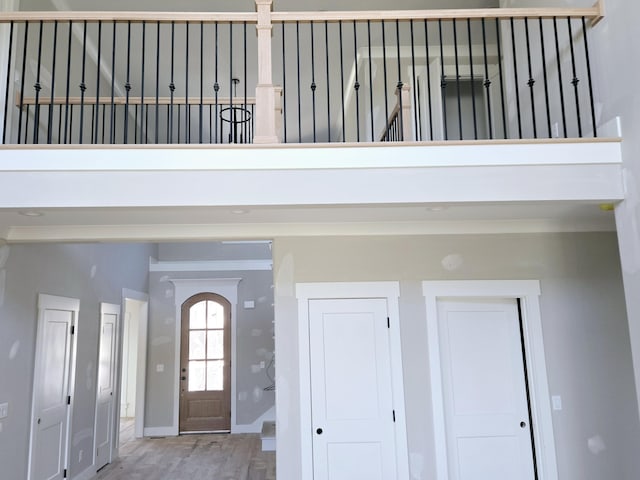 foyer entrance featuring a towering ceiling and hardwood / wood-style floors