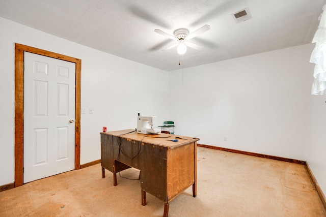 carpeted office featuring ceiling fan