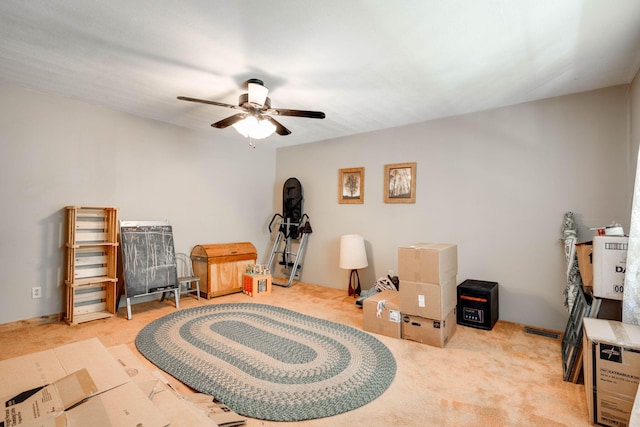 sitting room featuring light colored carpet and ceiling fan