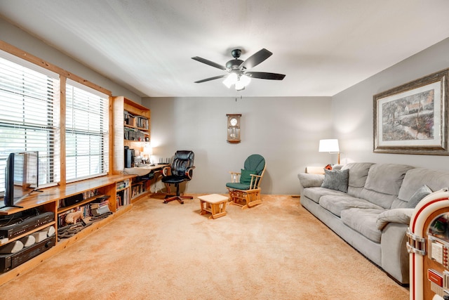 carpeted living room featuring ceiling fan