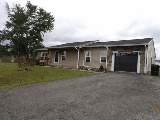 single story home featuring a front yard and a garage