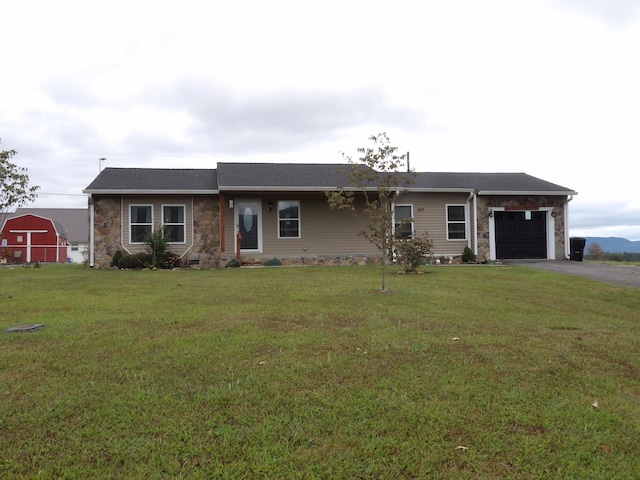 ranch-style home with a garage and a front lawn