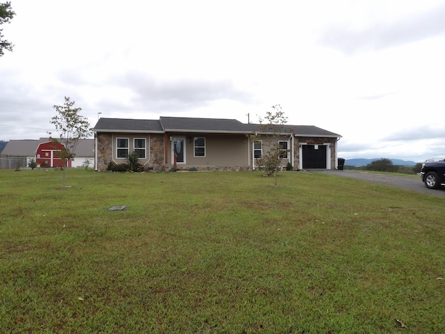 single story home featuring a front lawn and a garage