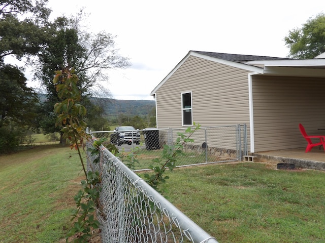 view of side of home featuring a lawn