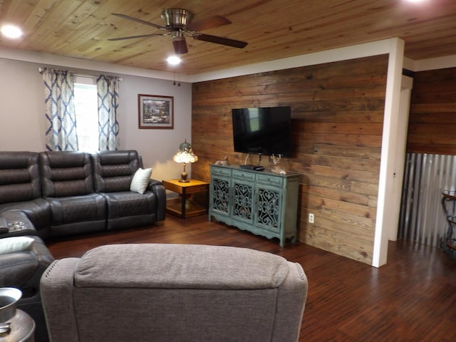 living room featuring ceiling fan, dark hardwood / wood-style flooring, wood walls, and wooden ceiling