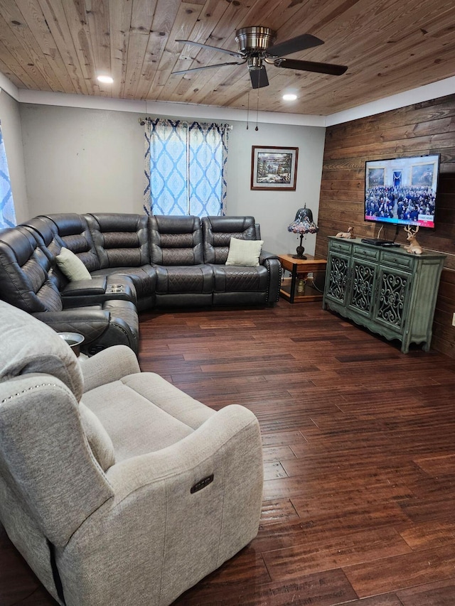 living room with dark hardwood / wood-style floors, ceiling fan, wood walls, and wooden ceiling