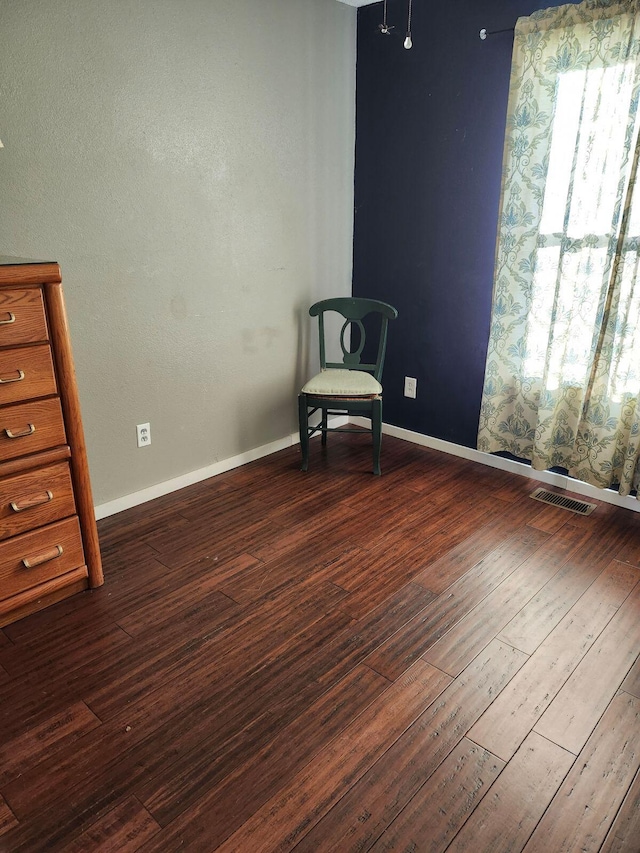 unfurnished room featuring dark wood-type flooring