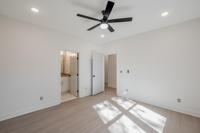 unfurnished bedroom featuring ceiling fan, connected bathroom, and light hardwood / wood-style floors