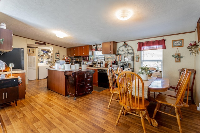 kitchen with stainless steel fridge, a textured ceiling, light hardwood / wood-style flooring, washer / clothes dryer, and black dishwasher