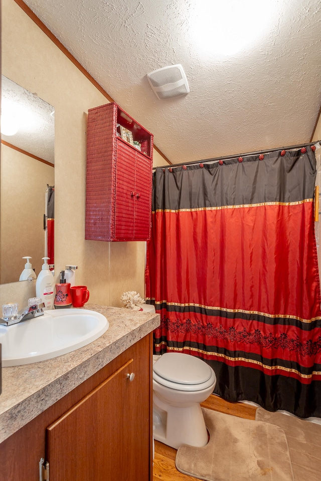 bathroom featuring vanity, a textured ceiling, tile patterned floors, a shower with curtain, and toilet