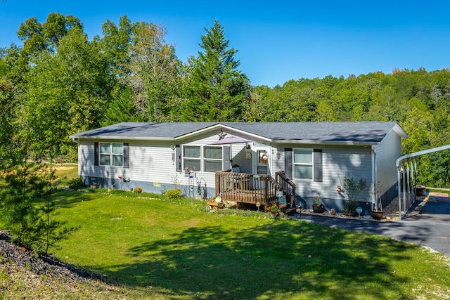 view of front of property with a front yard and a wooden deck