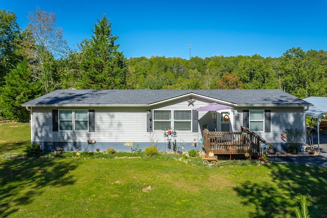 view of front of house featuring a front lawn and a deck