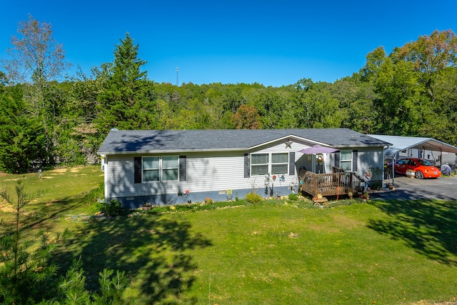 view of front of home featuring a deck, a carport, and a front lawn