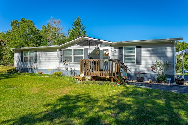 view of front of home featuring a front yard and a deck