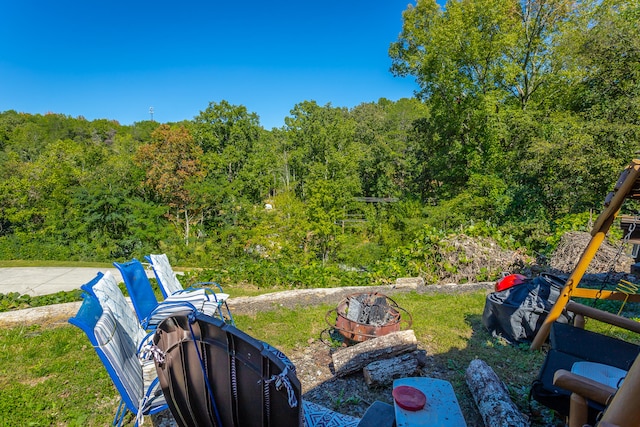 view of yard with a fire pit and a patio area