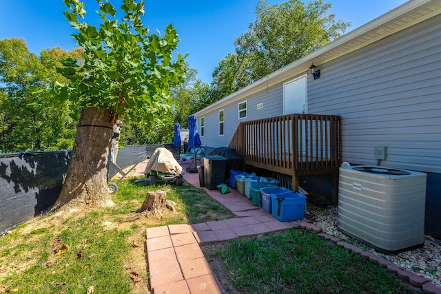 view of yard with central AC unit and a deck