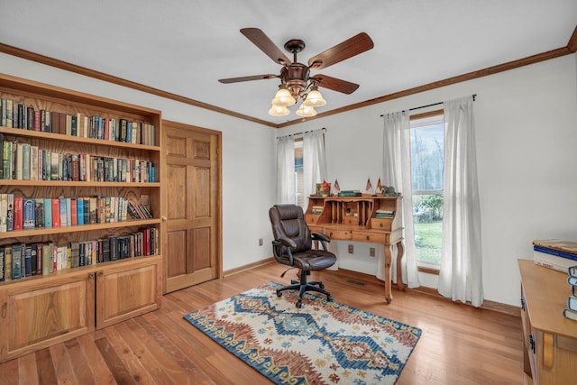 home office with light hardwood / wood-style floors, crown molding, and ceiling fan