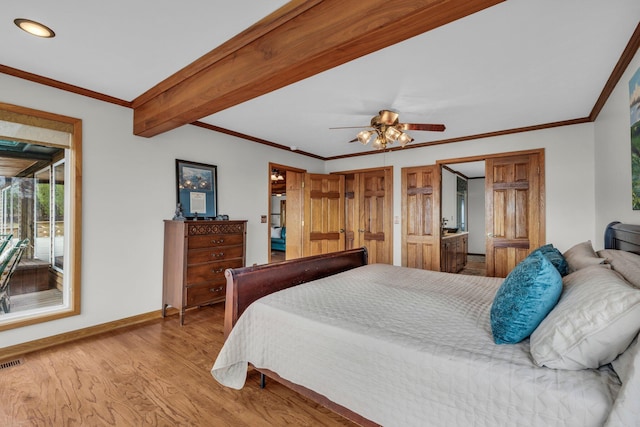 bedroom featuring ceiling fan, beamed ceiling, light wood-type flooring, and crown molding