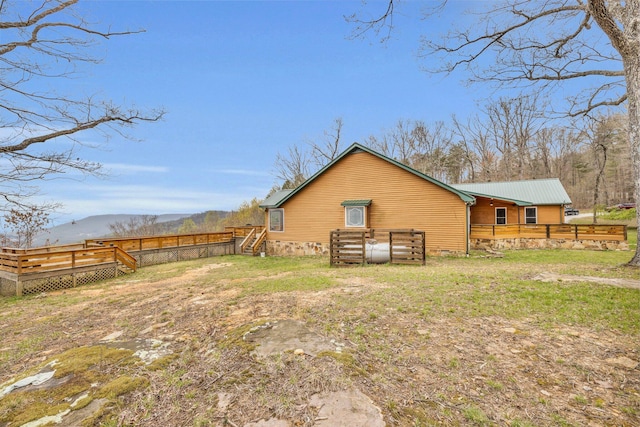 back of property featuring a deck with mountain view