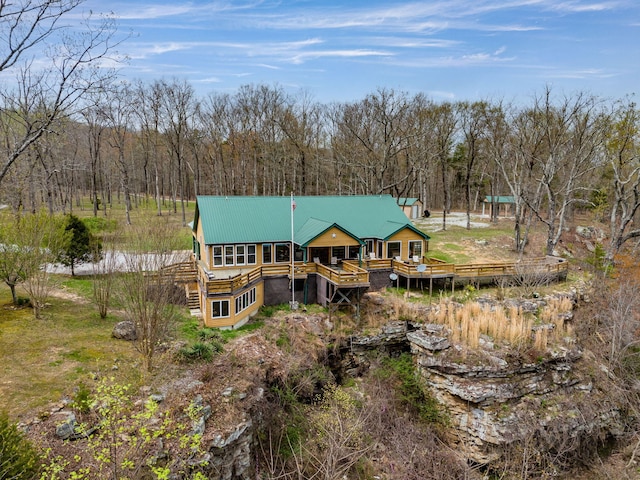 rear view of property featuring a deck