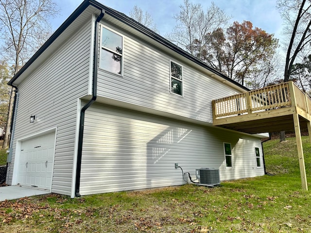 view of property exterior with a yard, central AC, a garage, and a deck