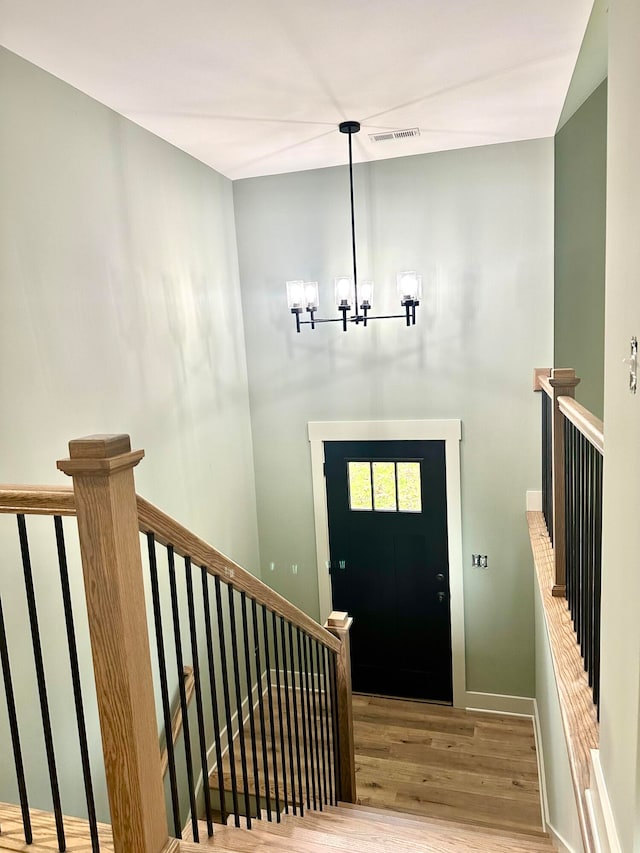 entryway featuring a notable chandelier and hardwood / wood-style flooring