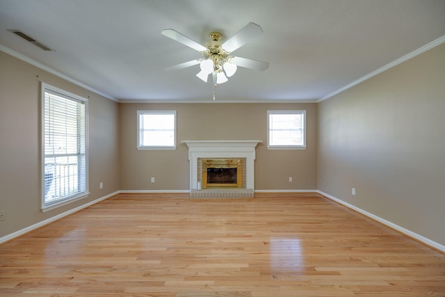 unfurnished living room featuring light hardwood / wood-style floors, a fireplace, plenty of natural light, and ceiling fan