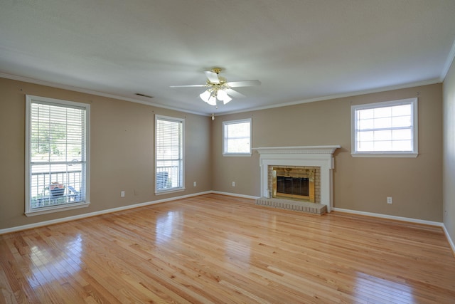 unfurnished living room featuring ceiling fan, ornamental molding, and light wood-type flooring