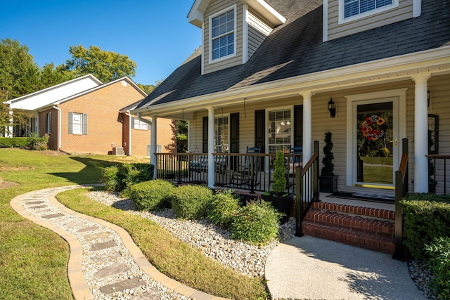 doorway to property with a yard and a porch