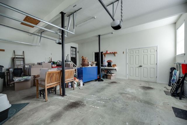 garage with a garage door opener and baseboards