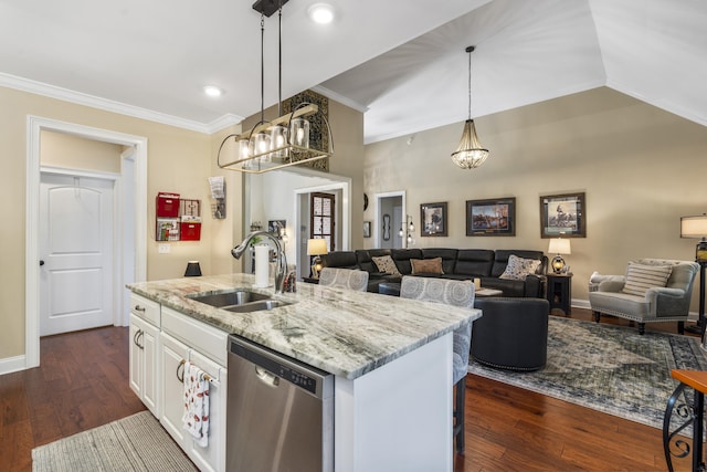 kitchen with an island with sink, hanging light fixtures, sink, stainless steel dishwasher, and white cabinetry