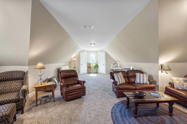 carpeted living room featuring vaulted ceiling