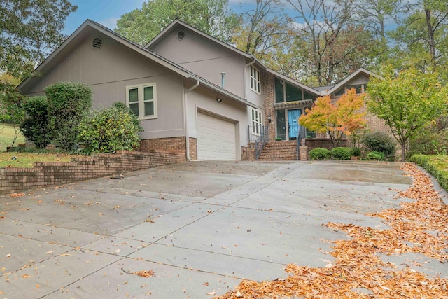 view of front facade with concrete driveway and brick siding