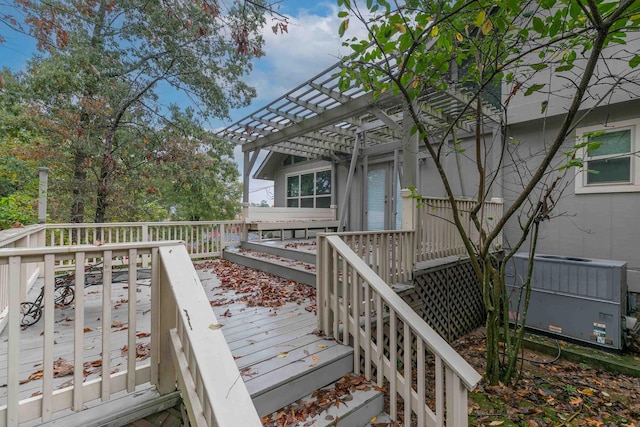 wooden deck featuring a pergola and central AC