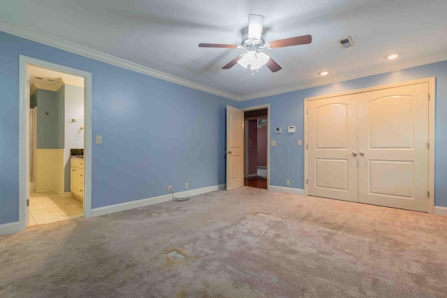 unfurnished bedroom featuring ceiling fan, light carpet, ornamental molding, and ensuite bathroom