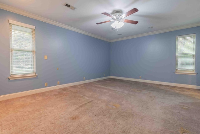 empty room featuring visible vents, crown molding, ceiling fan, and carpet floors
