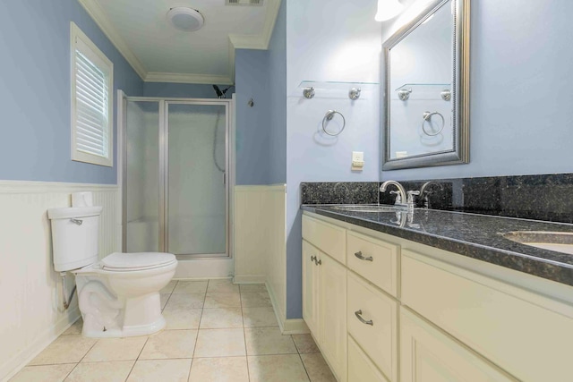 bathroom with a shower with door, tile patterned floors, toilet, ornamental molding, and vanity