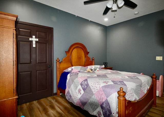 bedroom featuring ceiling fan and dark hardwood / wood-style flooring