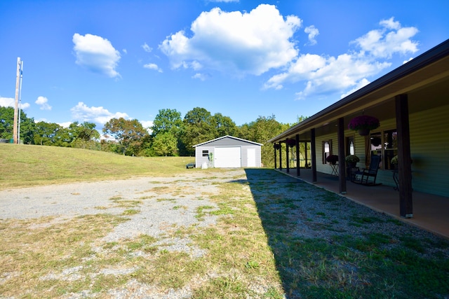 view of yard with an outdoor structure and a patio