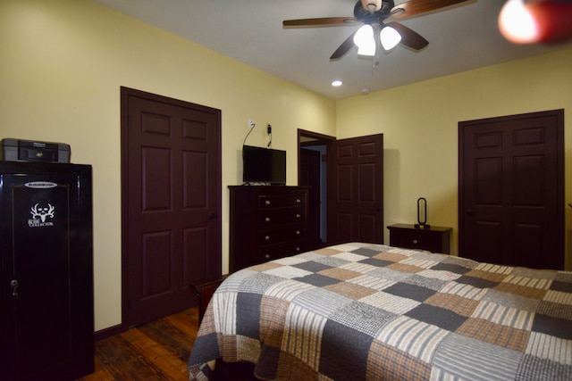 bedroom featuring dark hardwood / wood-style flooring and ceiling fan