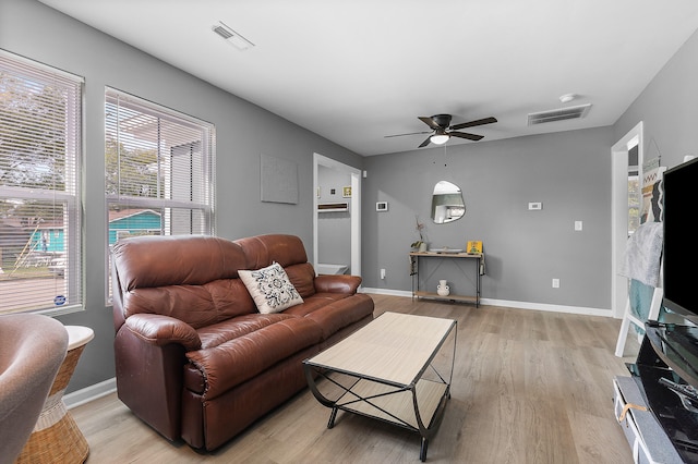 living room with light wood-type flooring and ceiling fan