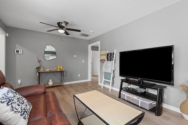 living room with wood-type flooring and ceiling fan