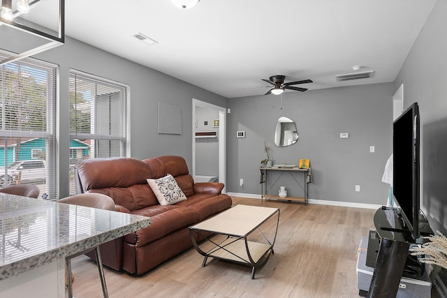 living room with ceiling fan and light wood-type flooring