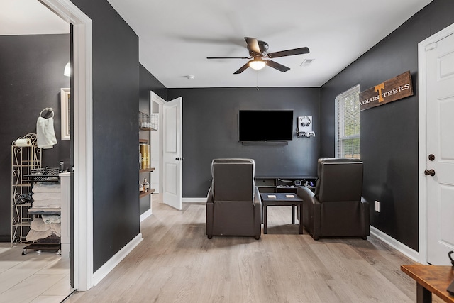 office area with light hardwood / wood-style floors and ceiling fan