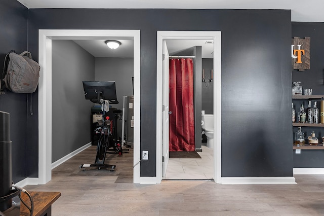 exercise area with light hardwood / wood-style floors