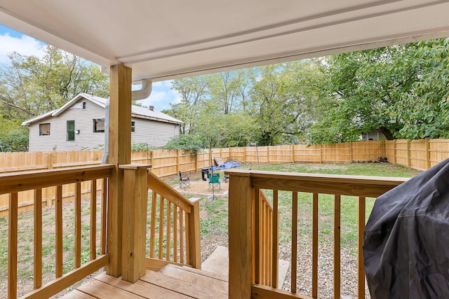 wooden deck featuring a yard