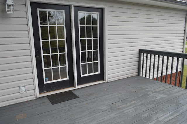 view of exterior entry featuring a wooden deck